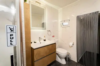 a bathroom with a sink and a toilet and a mirror at Luxury Getaway with Jacuzzi - Platanos House Salakos in Sálakos