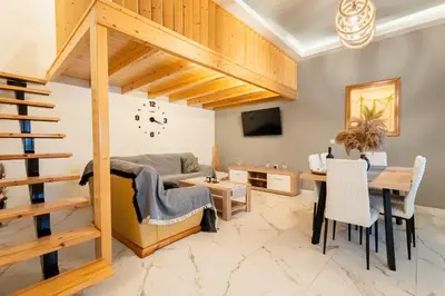 a living room with a couch and a table at Luxury Getaway with Jacuzzi - Platanos House Salakos in Sálakos