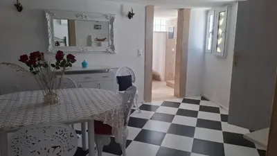 a kitchen with a table with a vase of flowers on it at Castellino Studios in Faliraki