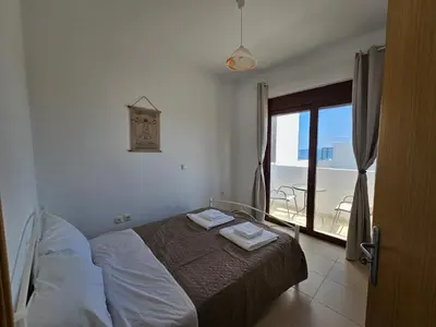 a bedroom with a bed with two towels on it at Villa Mare in Kiotari