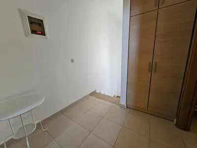 a white room with a table and a cabinet at Villa Mare in Kiotari