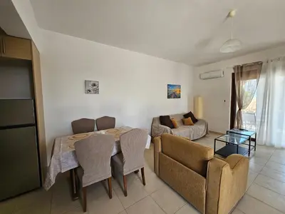 a living room with a table and chairs and a couch at Villa Mare in Kiotari