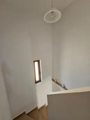 a room with a white wall and a window at Villa Mare in Kiotari