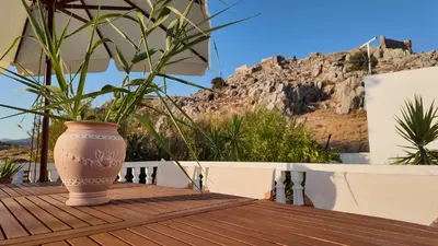 a vase sitting on a wooden table with a plant at Feraklion House in Haraki