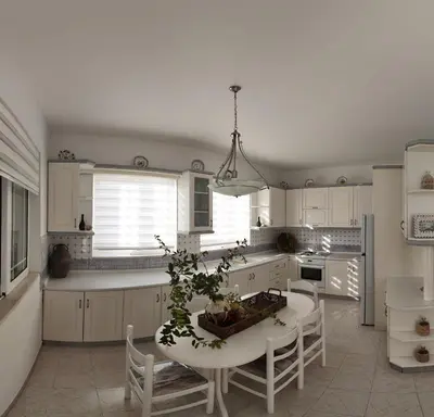 a kitchen with white cabinets and a table with a plant at Feraklion House in Haraki