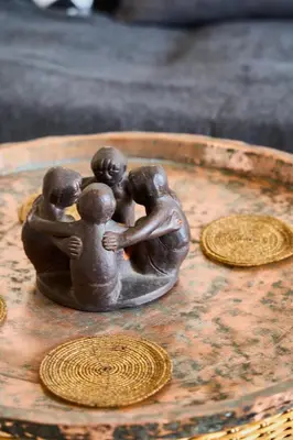 a bronze statue of three children on a table at Valley View Studio Apartment Salakos in Sálakos
