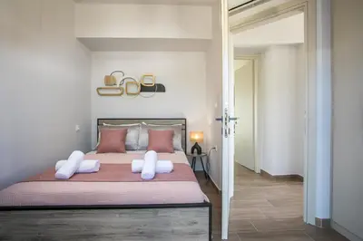 a bedroom with a large bed with white pillows at Maro Luxury Villa in Afantou