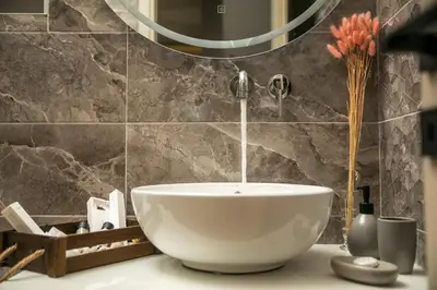 a bathroom with a white bowl sink and a faucet at Maro Luxury Villa in Afantou