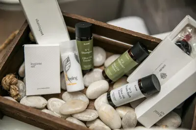 a wooden box filled with spa products and rocks at Maro Luxury Villa in Afantou
