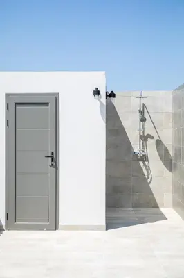 an open door in a bathroom with a staircase at Kiki Luxury Villa in Afantou