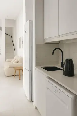a white kitchen with a sink and a refrigerator at Seapalm Villa - Elegant Stay - Steps from the Sea in Lachania