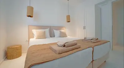 a bedroom with a large bed with towels on it at Seapalm Villa - Elegant Stay - Steps from the Sea in Lachania