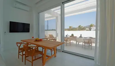 a dining room with a table and a large glass window at Seapalm Villa - Elegant Stay - Steps from the Sea in Lachania