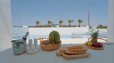 a table with fruit and vegetables in baskets on a table at Seapalm Villa - Elegant Stay - Steps from the Sea in Lachania