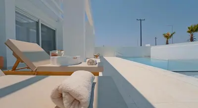 a stuffed animal is sitting on a ledge next to a swimming pool at Seapalm Villa - Elegant Stay - Steps from the Sea in Lachania