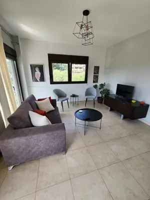 a living room with a couch and a table at Grande casa di Ialysos in Ixia