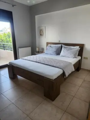 a large bed in a bedroom with a window at Grande casa di Ialysos in Ixia