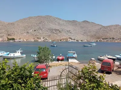 a group of boats in a body of water at Pedi Breeze in Symi