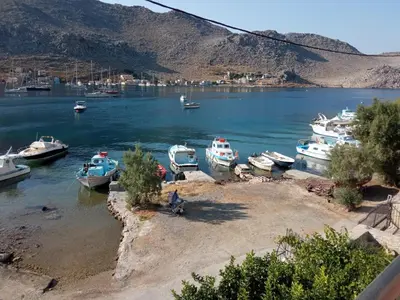 a group of boats docked in a body of water at Pedi Breeze in Symi