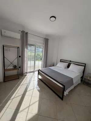 a bedroom with a bed and a large window at Jojo's Home in Kamiros