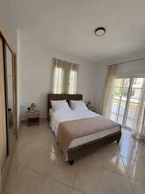 a bedroom with a large bed and a large window at Jojo's Home in Kamiros