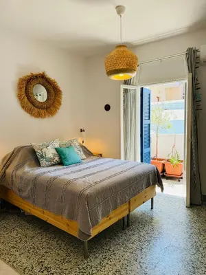 a bedroom with a bed and a mirror on the wall at Aelios City House in Rhodes Town