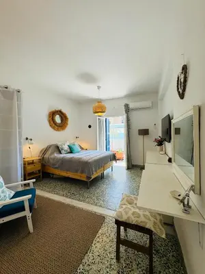 a bedroom with a bed and a living room at Aelios City House in Rhodes Town