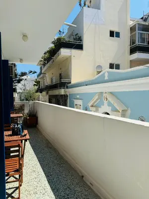 a balcony with a white fence and a building at Aelios City House in Rhodes Town
