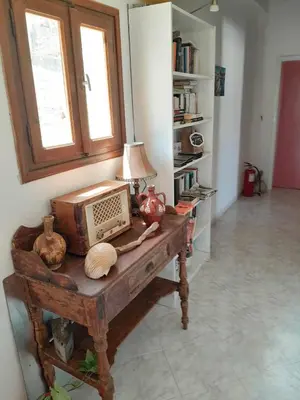a room with a table with a radio on it at Sevasti Symi Studios in Symi