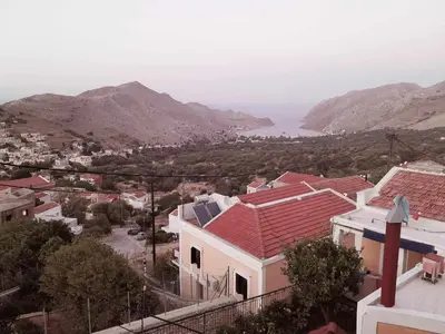a view of a town with mountains in the background at Sevasti Symi Studios in Symi