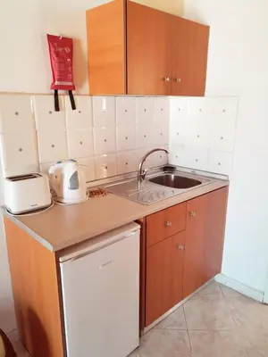 a small kitchen with a sink and a counter at Sevasti Symi Studios in Symi