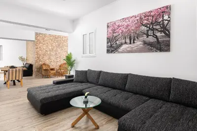 a living room with a couch and a painting on the wall at Sun Dream Apartment in Rhodes Town