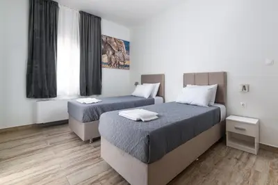 a room with two beds and a window at Sun Dream Apartment in Rhodes Town