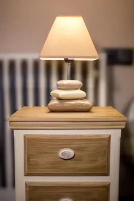 a table with a lamp on top of a dresser at Cozy near the sea-Sunset View Apartments in Ixia