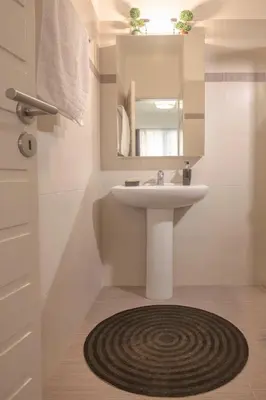 a bathroom with a sink and a mirror at Cozy near the sea-Sunset View Apartments in Ixia