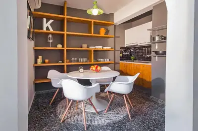 a kitchen with a white table and white chairs at Cozy near the sea-Sunset View Apartments in Ixia