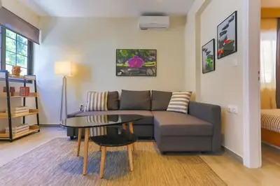 a living room with a couch and a table at Modern near the sea-Sunset View Apartments in Ixia