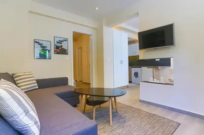 a living room with a couch and a table at Modern near the sea-Sunset View Apartments in Ixia