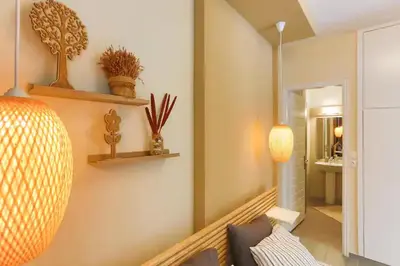 a living room with a couch and shelves on the wall at Modern near the sea-Sunset View Apartments in Ixia