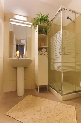 a bathroom with a sink and a glass shower at Modern near the sea-Sunset View Apartments in Ixia