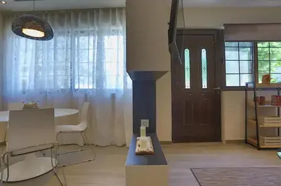 a living room with a table and a door at Modern near the sea-Sunset View Apartments in Ixia