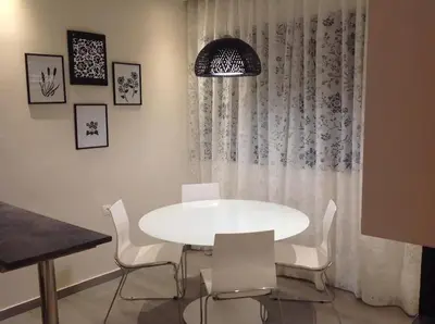 a white dining room with a white table and chairs at Modern near the sea-Sunset View Apartments in Ixia