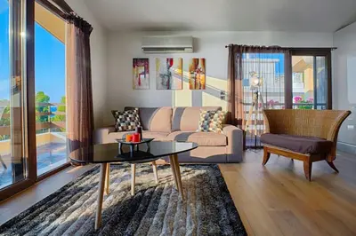 a living room with a couch and a table at Sea View-Sunset View Apartments in Ixia