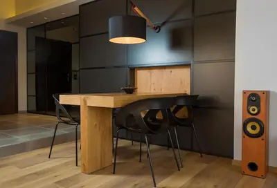a dining room table with chairs and a speaker at Sea View-Sunset View Apartments in Ixia
