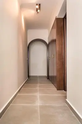 an empty hallway with a door and a tile floor at Sea View-Sunset View Apartments in Ixia