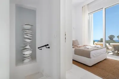 a white room with a bed and a window at Seadream - Luxury Villa - Pool & Sea View in Lachania