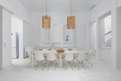 a white dining room with a table and white chairs at Seadream - Luxury Villa - Pool & Sea View in Lachania