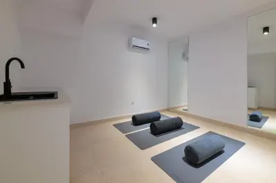 a living room with two gray chairs and a counter at Seadream - Luxury Villa - Pool & Sea View in Lachania