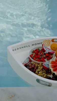 a bowl of fruit sitting in a swimming pool at Seadream - Luxury Villa - Pool & Sea View in Lachania