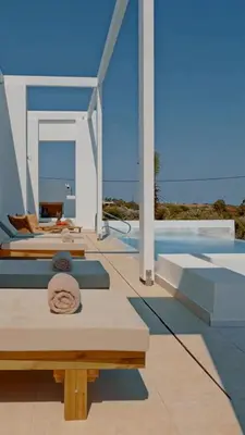 a patio with two beds and a pool at Seadream - Luxury Villa - Pool & Sea View in Lachania